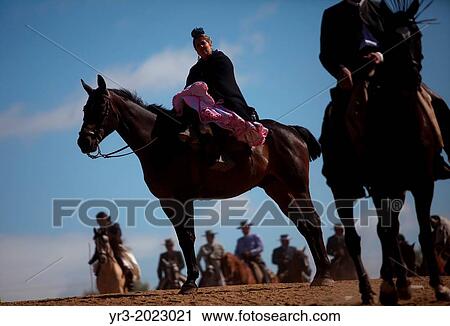 Stock Image - Riders wait to cross in the Guadiamar's river ford, known as Vado del Quema, during the pilgrimage to the shrine of the Virgin of Rocio, in Aznalcazar, Sevilla province, Andalusia, Spain. Fotosearch