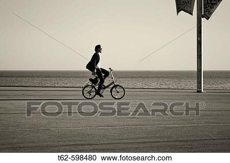 Riding a bicycle on the F? rum de Barcelona. Catalonia. Spain. View Large Photo Image Stock Image - Riding a bicycle on the F? rum de Barcelona. Catalonia. Spain.. Fotosearch
