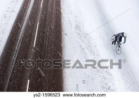 Riding a bike in the snow View Large Photo Image Stock Image - Riding a bike in the snow. Fotosearch