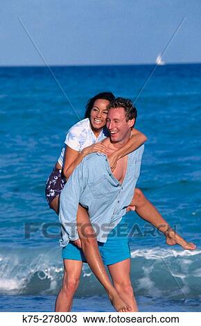 riding piggyback at the beach View Large Photo Image Stock Image - riding piggyback at the beach. Fotosearch