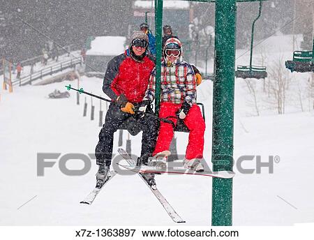 Stock Photo - Riding the Blackfoot chairlift at Grand Targhee Ski Resort near the town of Driggs in Eastern Idaho. Fotosearch