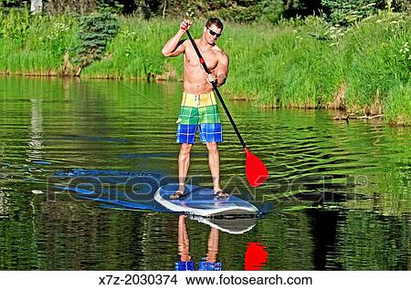riding the Stand Up Paddle Board on the North Fork of the Payette River near Payette Lake and the city of McCall in the Salmon River Mountains of central Idaho. View Large Photo Image Picture - riding the Stand Up Paddle Board on the North Fork of the Payette River near Payette Lake and the city of McCall in the Salmon River Mountains of central Idaho.. Fotosearch