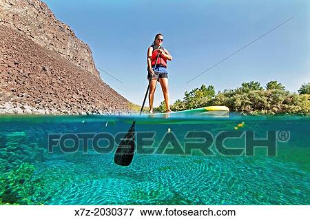 riding the Standup Paddle Board at Blue Heart Spring in the Snake River Canyon near the city of Hagerman in southern Idaho. View Large Photo Image Stock Photo - riding the Standup Paddle Board at Blue Heart Spring in the Snake River Canyon near the city of Hagerman in southern Idaho.. Fotosearch
