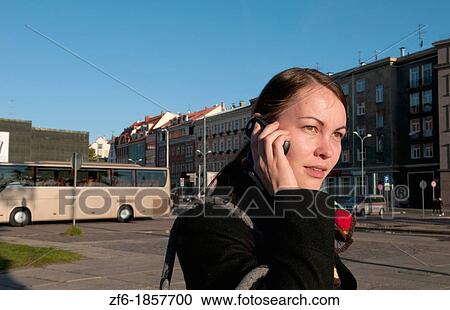 Riga Latvia modern woman on cell phone in downtown capital statue with scarf View Large Photo Image Stock Image - Riga Latvia modern woman on cell phone in downtown capital statue with scarf. Fotosearch