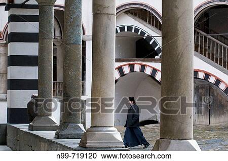 Rila monastery, arcades of Mary`s Birth Church, monk walking over the inner court, Bulgaria View Large Photo Image Stock Image - Rila monastery, arcades of Mary`s Birth Church, monk walking over the inner court, Bulgaria. Fotosearch