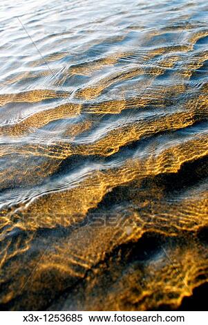 Ripples on calm shallow sea water surface View Large Photo Image Stock Photography - Ripples on calm shallow sea water surface. Fotosearch