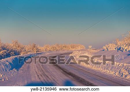 Stock Photograph - Road and frozen landscape, cold temperatures as low as -47 celsius, Lapland, Sweden.. Fotosearch