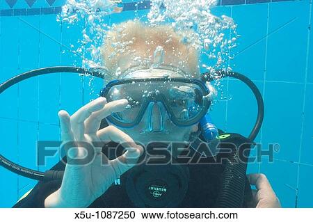 Stock Image - Roan, 8, Padi SEAL training in pool Red Sea, Egypt. Fotosearch