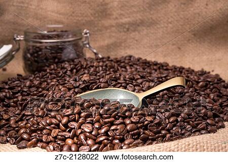 roasted coffee beans and brass scoop laying on a background of hessian sacking with a glass kilner jar in the background. View Large Photo Image Stock Image - roasted coffee beans and brass scoop laying on a background of hessian sacking with a glass kilner jar in the background.. Fotosearch