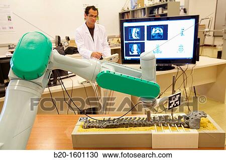Stock Image - Robotic system to assist surgery. Fotosearch