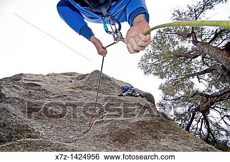 Stock Photograph - Rock climbing a route called Broke Back which is rated 5, 11 and located on the True Grit formation at Castle Rocks State Park near the town of Almo in southern Idaho. Fotosearch