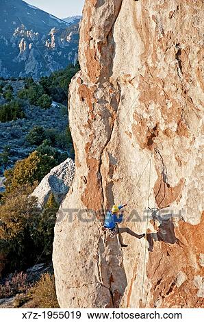 Stock Photo - Rock climbing a route called Fido which is rated 5, 11 and located on the Electric Avenue formation at The City Of Rocks National Reserve near the town of Almo in southern Idaho.. Fotosearch