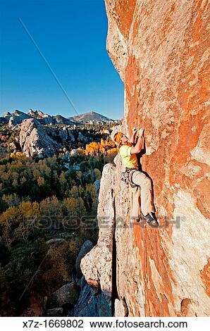 Stock Image - Rock climbing a route called Firewater which is rated 5, 11 and located on Flaming Rock at the City Of Rocks National Reserve near the town of Almo in southern Idaho. Fotosearch