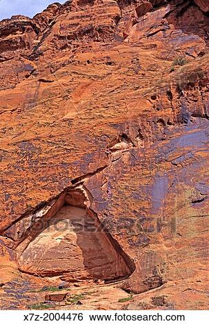 Stock Photograph - rock climbing a route called Living On The Edge which is rated Grade 2, 5, 10 and located on Circus Wall at Snow Canyon State Park in southern Utah.. Fotosearch