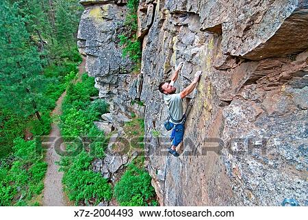 Stock Image - rock climbing a route called Pale Face which is rated 5, 9 and located at the Post Falls crags near the city of Post Falls in northern Idaho.. Fotosearch