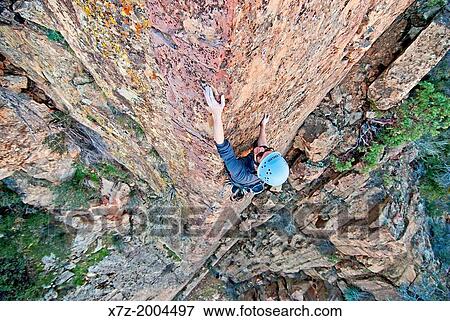 rock climbing a route called Permanent Income Hypothesis which is rated 5, 9 and located on The Fortress in the Sespe Mountains in southern California. View Large Photo Image Stock Photo - rock climbing a route called Permanent Income Hypothesis which is rated 5, 9 and located on The Fortress in the Sespe Mountains in southern California.. Fotosearch