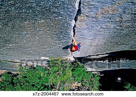 Stock Photo - rock climbing a route called Reeds Pinnacle Direct which is rated 5, 10 and located on Reeds Pinnacle in Yosemite Valley at Yosemite National Park in California.. Fotosearch