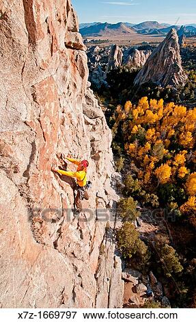 Stock Photo - Rock climbing a route called Shes The Bosch which is rated 5, 11 and located on Window Rock at The City Of Rocks National Reserve near the town of Almo in southern Idaho. Fotosearch