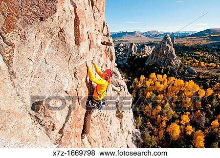 Stock Photo - Rock climbing a route called Shes The Bosch which is rated 5, 11 and located on Window Rock at The City Of Rocks National Reserve near the town of Almo in southern Idaho. Fotosearch