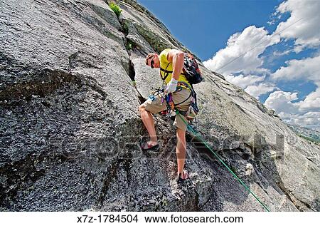rock climbing a route called the Regular Route which is rated 5, 6 and located on Slick Rock near the city of McCall in the Salmon River Mountains of central Idaho View Large Photo Image Picture - rock climbing a route called the Regular Route which is rated 5, 6 and located on Slick Rock near the city of McCall in the Salmon River Mountains of central Idaho. Fotosearch