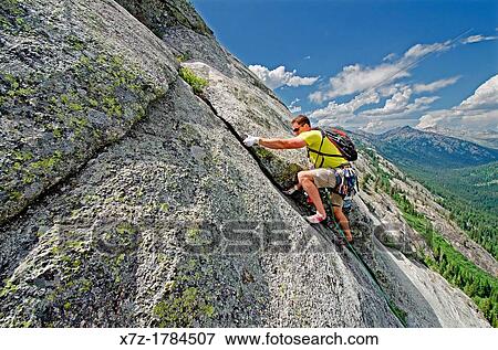 rock climbing a route called the Regular Route which is rated 5, 6 and located on Slick Rock near the city of McCall in the Salmon River Mountains of central Idaho View Large Photo Image Stock Photo - rock climbing a route called the Regular Route which is rated 5, 6 and located on Slick Rock near the city of McCall in the Salmon River Mountains of central Idaho. Fotosearch