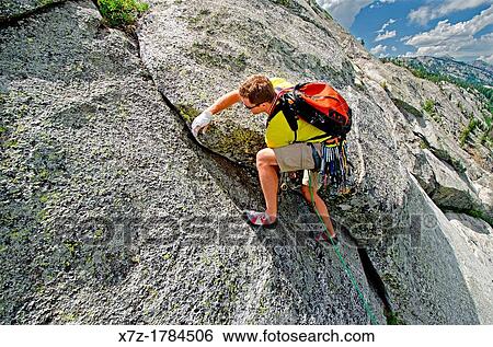 Stock Photograph - rock climbing a route called the Regular Route which is rated 5, 6 and located on Slick Rock near the city of McCall in the Salmon River Mountains of central Idaho. Fotosearch