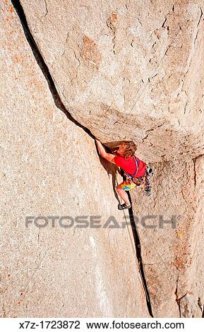 Stock Image - rock climbing a route called White Lightning which is rated 5, 10 and located at The City Of Rocks National Reserve near the town of Almo in southern Idaho. Fotosearch