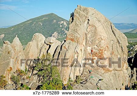 Stock Photo - rock climbing Swiss Cheese which is rated 5, 7 and located on the Anteater at The City Of Rocks National Reserve near the town of Almo in southern Idaho. Fotosearch