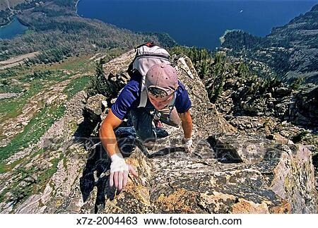Stock Image - rock climbing the East Ridge route which is rated 5, 4 and located on Cube Point high above Jenny Lake in Grand Teton National Park in northern Wyoming.. Fotosearch