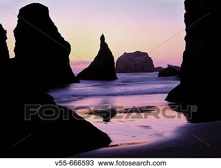 Stock Image - Rock monoliths in sunset at Bandon Beach. Oregon Coast. Fotosearch