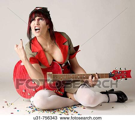 Rocker girl dressed as a nurse sitting down among a pool of pills looking up signalling with her hand View Large Photo Image Stock Image - Rocker girl dressed as a nurse sitting down among a pool of pills looking up signalling with her hand. Fotosearch