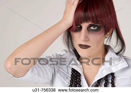 Rocker girl with heavy makeup and tear running down View Large Photo Image Stock Photo - Rocker girl with heavy makeup and tear running down. Fotosearch