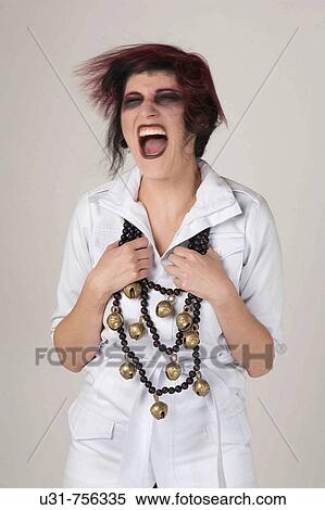 Stock Photography - Rocker girl with shaking her head screaming in desperation. Fotosearch