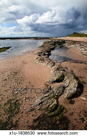 Rocks on the Beach and Stormclouds at Carnoustie Angus Scotland View Large Photo Image Stock Image - Rocks on the Beach and Stormclouds at Carnoustie Angus Scotland. Fotosearch