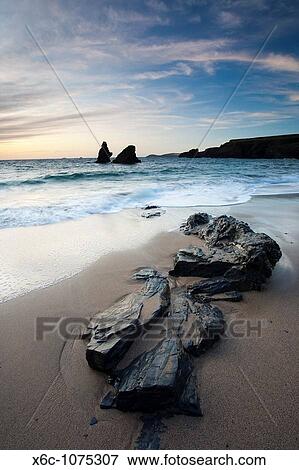 Rocks on the beach at Sunset, Porthcothan Bay Cornwall England View Large Photo Image Stock Photo - Rocks on the beach at Sunset, Porthcothan Bay Cornwall England. Fotosearch