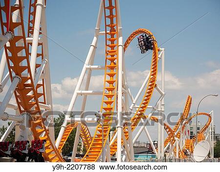 Roller coaster enthusiasts flock to Coney Island in Brooklyn in New York for the grand opening of the new Thunderbolt roller coaster.. View Large Photo Image Stock Photo - Roller coaster enthusiasts flock to Coney Island in Brooklyn in New York for the grand opening of the new Thunderbolt roller coaster... Fotosearch
