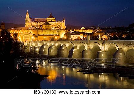 Roman bridge over Guadalquivir river with Great Mosque in background at night, Cordoba. Andalusia, Spain View Large Photo Image Stock Photo - Roman bridge over Guadalquivir river with Great Mosque in background at night, Cordoba. Andalusia, Spain. Fotosearch
