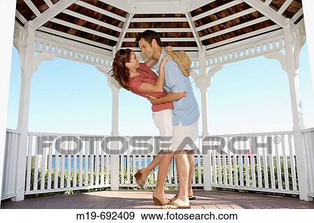 Stock Photo - Romantic couple dancing in a Gazebo. Fotosearch