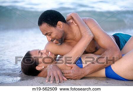 Stock Photo - romantic couple embracing on the beach. Fotosearch