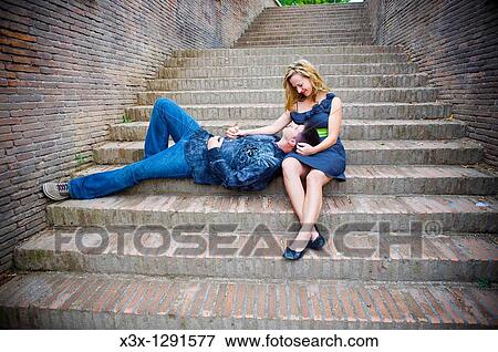 Romantic couple laying on stairs in Rome Italy View Large Photo Image Stock Photo - Romantic couple laying on stairs in Rome Italy. Fotosearch