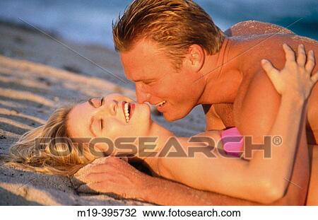 romantic couple lying on the beach View Large Photo Image Stock Image - romantic couple lying on the beach. Fotosearch