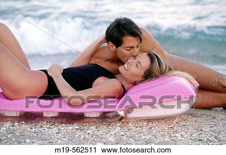 Stock Image - romantic couple on the beach. Fotosearch