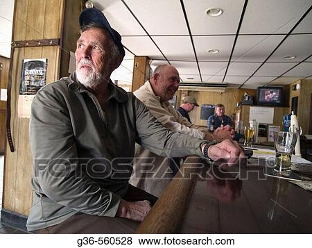 Ron Turgeon, Quahogger, gets a drink at a bar in East Greenwich, Rhode Island after day of shellfishing. View Large Photo Image Stock Photo - Ron Turgeon, Quahogger, gets a drink at a bar in East Greenwich, Rhode Island after day of shellfishing.. Fotosearch