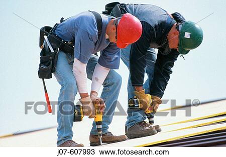 Stock Image - Roof construction workers. Fotosearch
