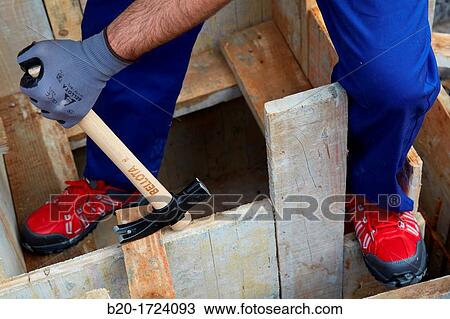 Stock Image - Roofing hammer, hand tools for construction, construction worker, Preparation of formwork for construction of pit with concrete, House Construction, Basque Country, Spain. Fotosearch