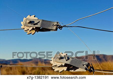 Stock Image - Rotary fence wire tensioners. Fotosearch