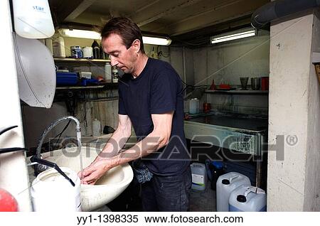 Rotterdam, Netherlands. Employee washing his hands after an job. View Large Photo Image Stock Photography - Rotterdam, Netherlands. Employee washing his hands after an job.. Fotosearch