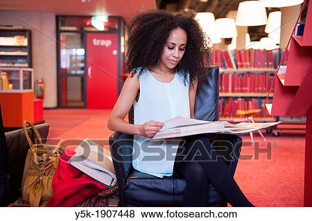 Rotterdam, Netherlands. Young, African woman reading educational literature about photography in a public Library. View Large Photo Image Stock Photo - Rotterdam, Netherlands. Young, African woman reading educational literature about photography in a public Library.. Fotosearch