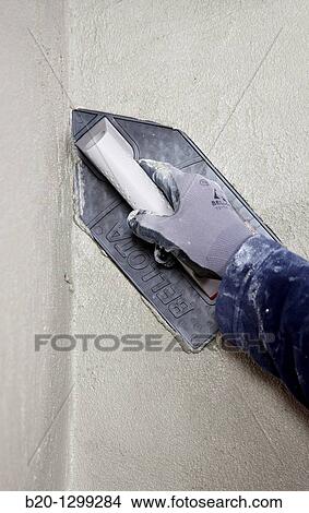 Roughcast, plastering trowel, new homes under construction, construction site View Large Photo Image Picture - Roughcast, plastering trowel, new homes under construction, construction site. Fotosearch