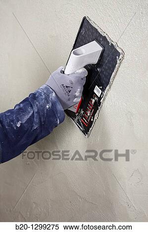 Stock Photography - Roughcast, plastering trowel, new homes under construction, construction site. Fotosearch